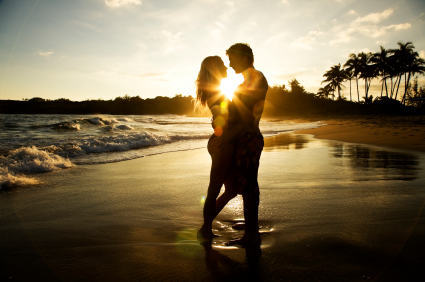 Idyllic picture of a newly married couple enjoying their honeymoon on a tropical beach